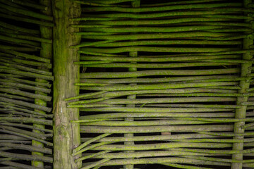 ancient house wall made of twigs of tree branches