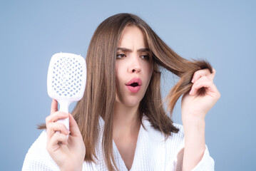 Hair loss woman with a comb and problem hair. Hairloss and hairs problems. Sad girl with damaged hair. Tangling hairs. Girl combing damaged hairs. Alopecia, dandruff. Tangled, frizzy, messy hair.