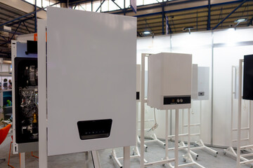 Samples of home heating boilers on stands.