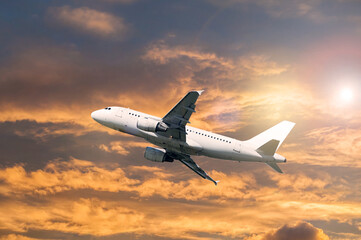 Travel background with white commercial airplane flying in the blue sky