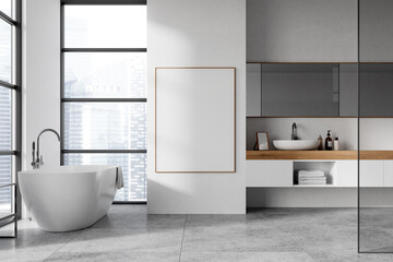 A modern bathroom with a large framed poster on a wall. Minimalist design with a bathtub and a vanity unit. Light background. Mockup concept.  3D Rendering