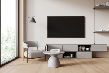 Modern minimalist living room with a gray armchair, table, television, shelves on a light...