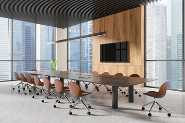 Modern conference room with a long table, multiple chairs, sleek wooden walls, and large windows...