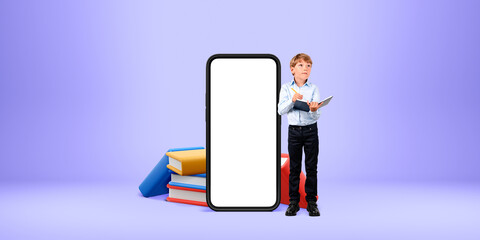 Boy holding tablet next to a giant phone with blank screen, book