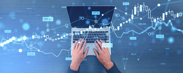 Businessman typing on computer, business forex chart and growing lines