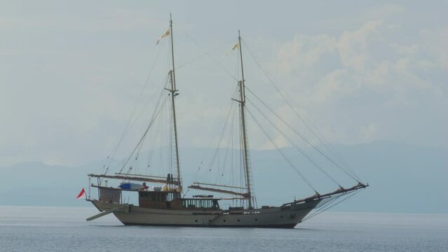 two-masted yacht anchored near Kri Island, Raja Ampat, Indonesia. Static shot.