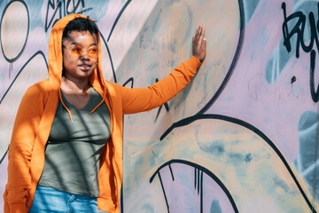 woman leaning on graffiti wall