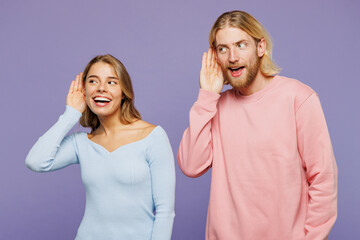Young curious nosy couple two friends family man woman wear pink blue casual clothes together try...