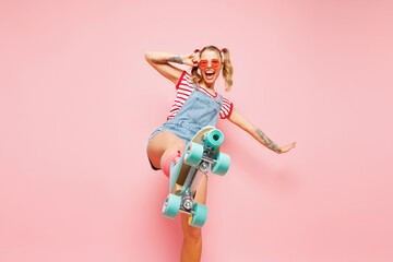 Bottom view young happy woman wear red t-shirt denim overalls casual clothes blue rollers...