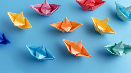 Colorful Origami Boats Arranged on a Blue Background