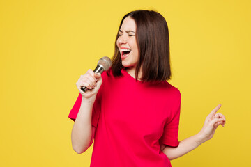 Young happy singer expressive Caucasian woman she wear pink t-shirt casual clothes sing song in...
