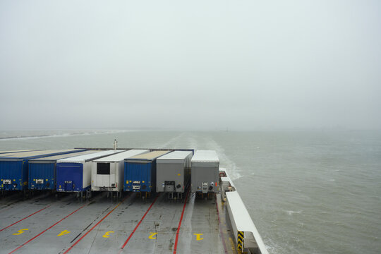 Back of container ship sailing during foggy weather - Powered by Adobe