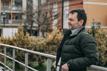 relaxed mature man on the street breathing fresh air