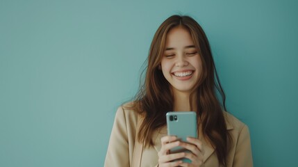 Naklejka premium Businesswoman smile happy laugh holding smartphone cellphone long hair Asian female clean simple background copy space