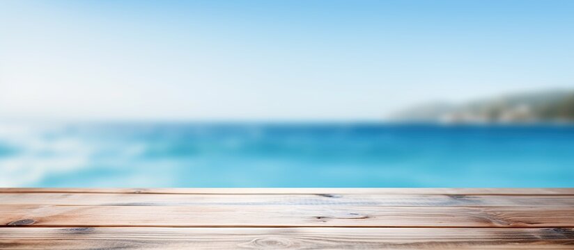 Product placement potential on a blue wooden board with a blurred sparkling sea in the background, perfect for a summer holiday concept with copy space image.