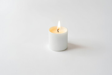 Close-Up of a Lit White Candle on a White Background