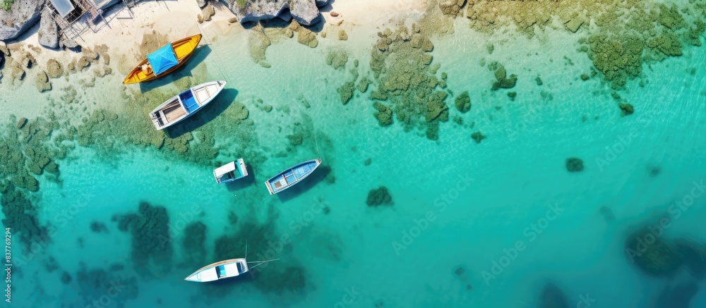 Poster drone captures an aerial bird's eye view image of a tropical seascape with clear turquoise waters an