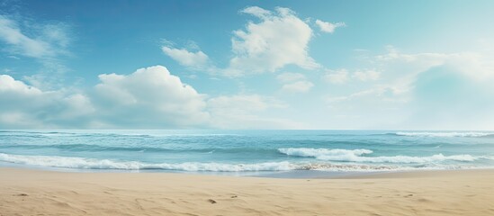 Fototapeta premium Sandy beach backdrop with sea and sky, embodying a summer theme, perfect for a copy space image.