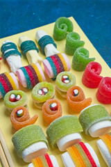 Various jelly strips, candies and marshmallows arranged to look like sushi
