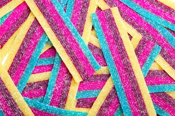 Close-up of Sour jelly candy strips in rainbow colors.