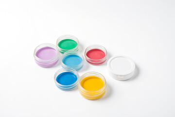 Colorful paint pots on a white background