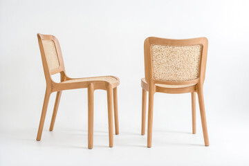 Fototapeta premium Two wooden chairs with wicker backs on a white background