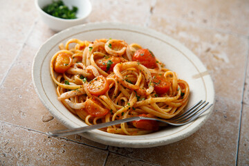 Homemade pasta with tomatoes and squid