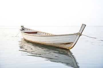 Fototapeta premium White Wooden Boat in Calm Water