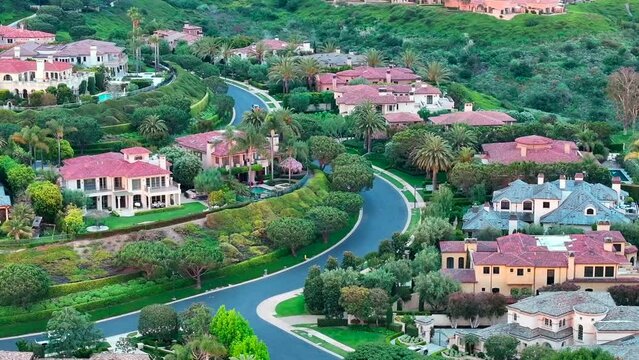NEWPORT BEACH, CALIFORNIA &ndash; 2024/05/25: Aerial footage of the luxurious Pelican Hill area in Newport Beach, California. The video showcases Mediterranean-style villas and mansions with red-tiled roofs