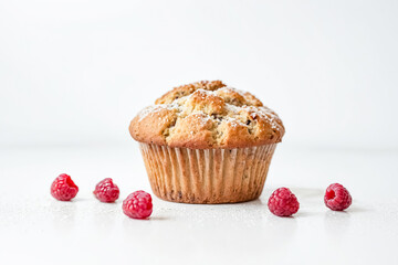 Close-up of a muffin with raspberries on a white background