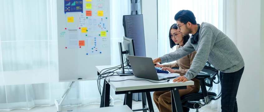 asian and Indian Developer team discussion feedback analysis coding data with software computer at office