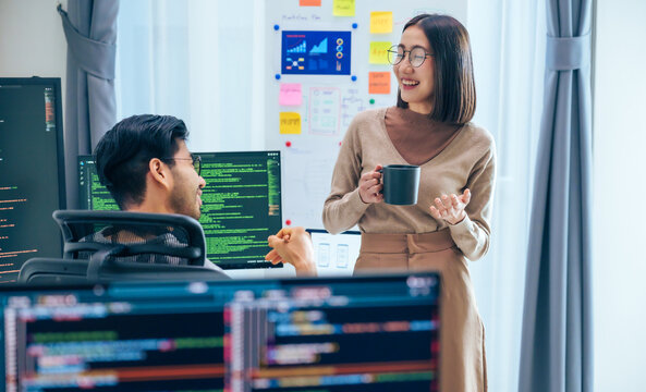 Two software developers engage in a discussion at coffee break time in a modern office, relax emotion