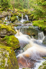 waterfalls with mossy stones in Jizera mountains on autumn time