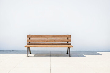 Empty Wooden Bench in Front of White Wall