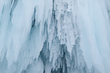 Ice stalactites on cliff in winter season