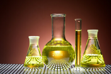 Erlenmeyer glass flask placed in a laboratory table with yellow liquid