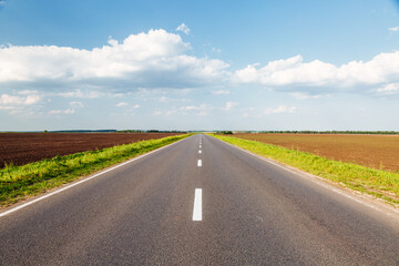 The country road passes through agricultural land.