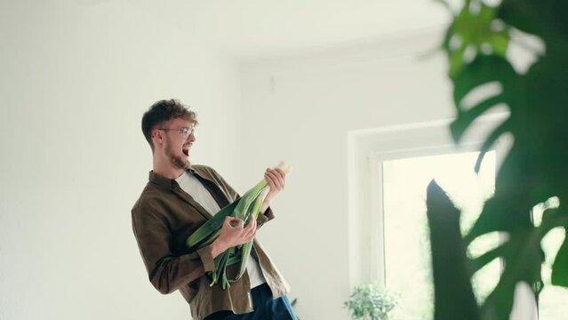 Young man playing a leek guitar