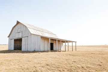 White barn in a dry field