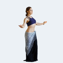 Stylish beautiful young dancer girl dancing oriental belly dancing on a light background