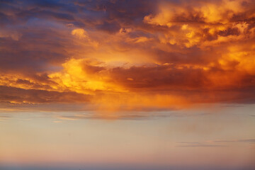 Incredible colorful sunset with cloudy sky lit by the sun.