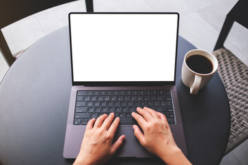 Top view mockup image of a woman using and typing on laptop with blank white desktop screen