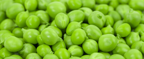 Green peas pattern on a natural background. Healthy vegetarian food.