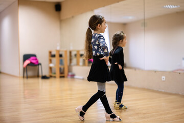 Young Girls Practicing Ballet in Dance Studio with Mirror Reflection