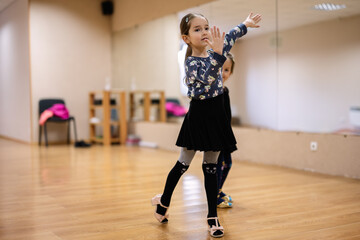 Young Girl Practicing Dance Moves In Studio With Mirror
