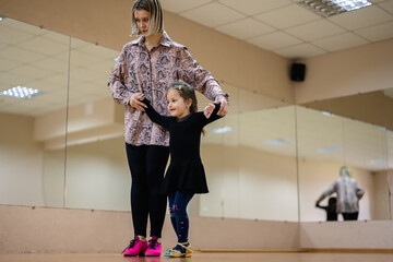 Young Girl Learning Ballet with Instructor in Dance Studio