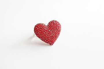 Red heart ring on white background