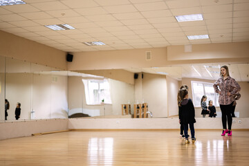 Young Girl in Dance Studio Taking Ballet Class with Instructor