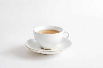 Obraz premium White Teacup and Saucer with Gold Trim on White Background