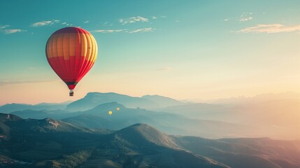 Obraz premium Hot Air Balloon Floating in Clear Sky with Mountains